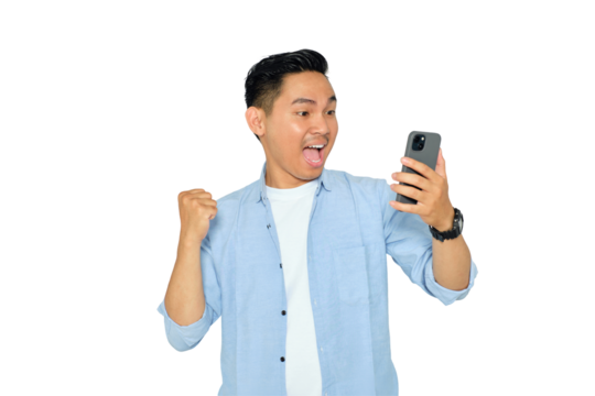 Happy young Asian man in casual clothes using mobile phone for trading or chatting and making winning gesture isolated on transparent background