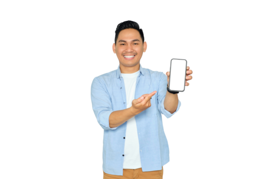 Happy young Asian man in casual clothes pointing index finger at mobile phone with blank screen isolated on transparent background. Advertising new mobile app, mockup concept - Powered by Adobe