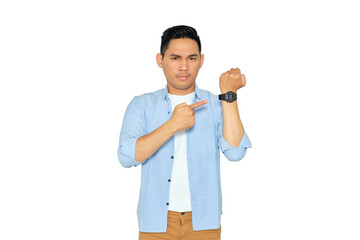 Time is out. Portrait of serious young Asian man in casual clothes looking at camera and pointing...