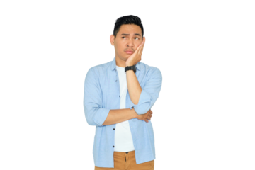 Portrait of bored young Asian man in casual clothes holding his cheek and feeling frustrated, having problems isolated on transparent background