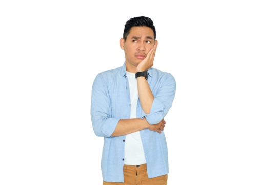 Portrait of bored young Asian man in casual clothes holding his cheek and feeling frustrated, having problems isolated on transparent background