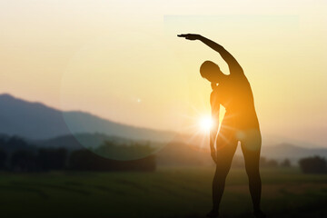 Silhouette of Woman Practicing Yoga Outdoors at Sunset