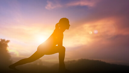 Silhouette of Woman Practicing Yoga Outdoors at Sunrise