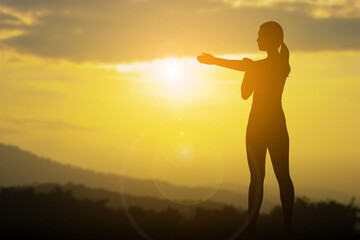 Silhouette of Woman Practicing Yoga Outdoors at Sunset