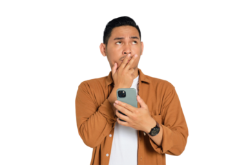 Confused young Asian man in casual shirt holding mobile phone and looking up, thinking about question isolated on transparent background