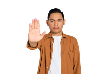 Unhappy young Asian man in casual shirt making stop gesture with his hands isolated on transparent...