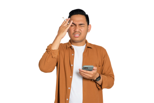 Tired young Asian man in casual shirt holding smartphone and cigarette having headache isolated on transparent background