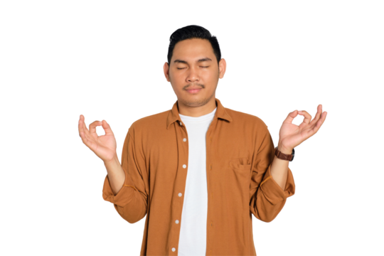 Calm young Asian man in casual shirt meditating with closed eyes isolated on transparent background