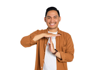 Happy smiling young Asian man in casual shirt showing time out gesture with hands isolated on transparent background