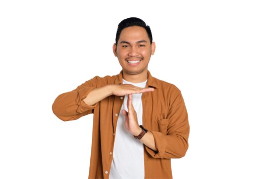 Happy smiling young Asian man in casual shirt showing time out gesture with hands isolated on transparent background