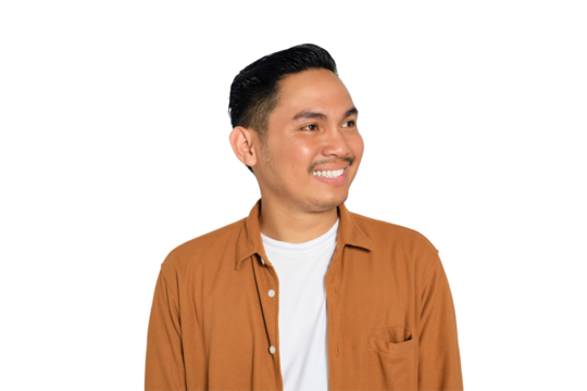 Smiling young Asian man in casual shirt looking aside at copy space isolated on transparent background