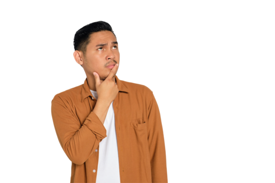 Thoughtful young Asian man in casual shirt touching his chin, looking up, thinking and making decisions isolated on transparent background