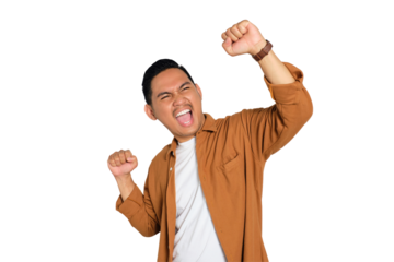 Big win. Excited young Asian man in casual shirt celebrating success with raised fist isolated on transparent background