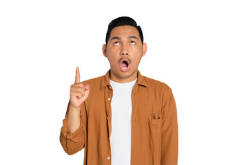 Excited young Asian man in casual shirt pointing finger up, having great idea isolated on...