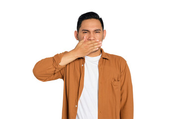 Handsome young Asian man in casual shirt covering mouth with hand palm, looking at camera isolated...