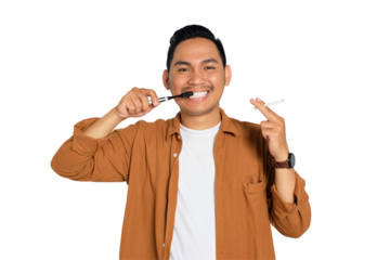 Happy young Asian man in casual shirt brushing his teeth with toothbrush while holding cigarette isolated on transparent background