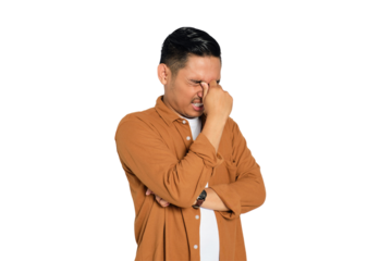 Portrait of tired young Asian man in casual shirt rubbing eyes with finger isolated on transparent background