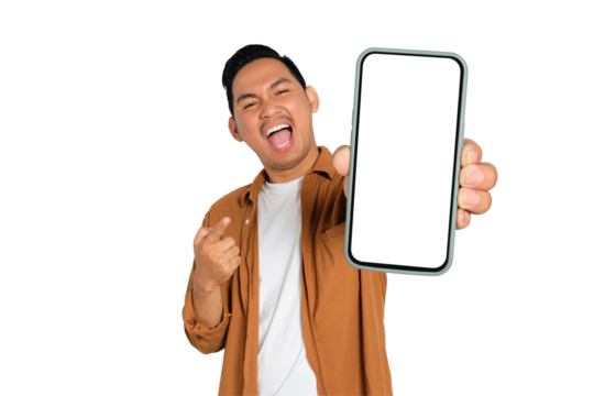 Excited young Asian man in casual shirt holding smartphone with blank screen, pointing at device isolated on transparent background