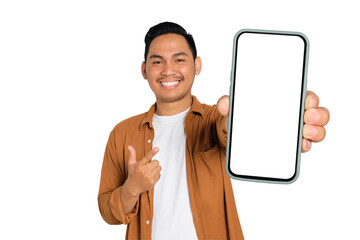 Excited young Asian man in casual shirt holding smartphone with blank screen, pointing at device...