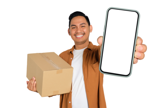 Happy young Asian man in casual shirt holding smartphone with blank screen and cardboard box isolated on transparent background