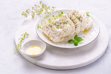 Raw halloumi, Cyprus squeaky cheese with herbs and olive oil prepared for grill