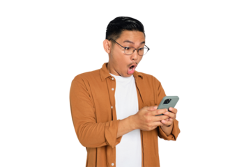 Surprised young Asian man in casual shirt using mobile phone with open mouth, reading great news message isolated on transparent background