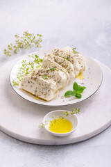 Raw halloumi, Cyprus squeaky cheese with herbs and olive oil prepared for grill