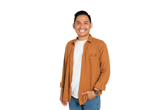 Smiling young Asian man in casual shirt posing with hands in pockets and confidently looking at camera isolated on transparent background