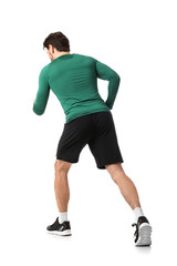 Sporty young man running marathon on white background, back view