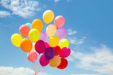 Many colorful air balloons on cloudy sky background
