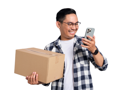 Happy young Asian man in casual shirt holding package box and using mobile phone for online shopping isolated on transparent background