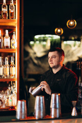 Bartender Making Cocktails at a Stylish Bar with Warm Lighting