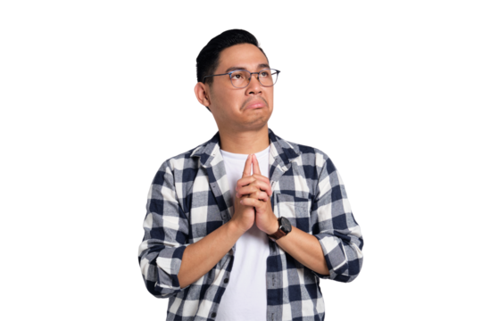 Pensive young Asian man in casual shirt looking up, thinking and making decision isolated on transparent background