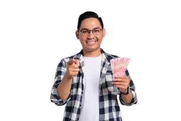 Successful financial planning. Smiling young Asian man in casual shirt holding money and pointing finger at camera isolated on transparent background