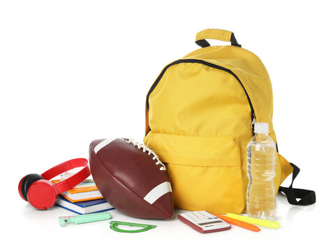 Backpack, school supplies and sports equipment isolated on white background
