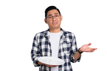 Confused young Asian man in casual shirt holding empty blank plate isolated on transparent background