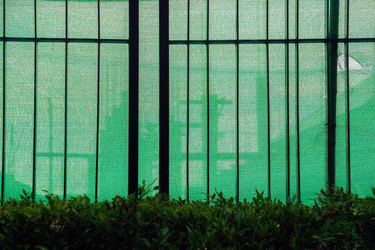 Green slanding net is used to cover the electric train base structure, used for temporary wall around construction site, fence prevents dust from construction site.