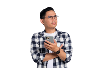 Pensive young Asian man in casual shirt holding smartphone, looking aside at copy space, thinking about offer isolated on transparent background