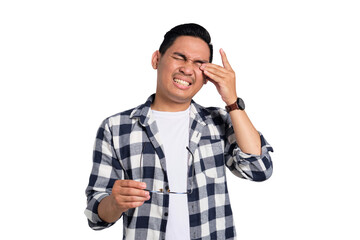 Tired young Asian man in casual shirt taking off glasses, feeling eye strain after work isolated on...