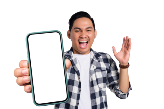 Surprised young Asian man in casual shirt holding smartphone with blank screen, raising arms with happy expression isolated on transparent background