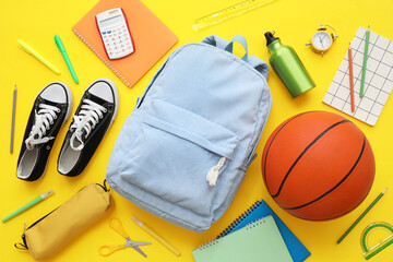 Composition with backpack, school supplies and sports equipment on yellow background