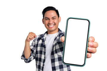 Yes. Excited young Asian man in casual shirt holding smartphone with blank screen and clenching fist, celebrating victory isolated on transparent background