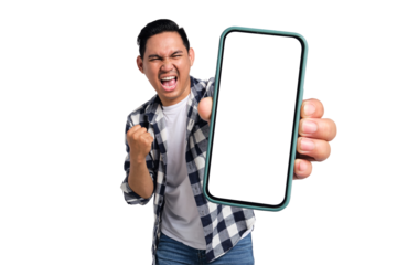 Yes. Excited young Asian man in casual shirt holding smartphone with blank screen and clenching fist, celebrating victory isolated on transparent background