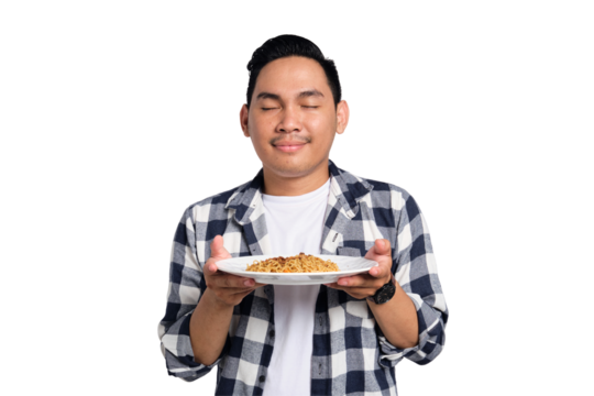 Happy young Asian man in casual shirt enjoying eating noodles with fork isolated on transparent background