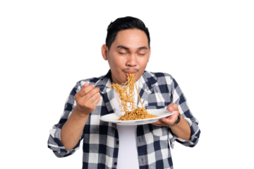 Happy young Asian man in casual shirt enjoying eating noodles with fork isolated on transparent background