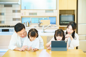 タブレットPCの画面を見る親子