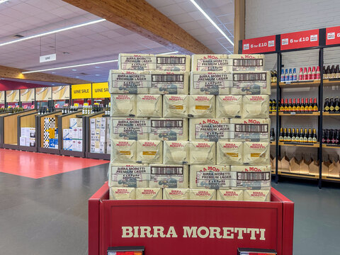 Stacked Birra Moretti beer crates placed prominently in promotional area of liquor section