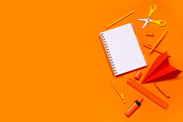 Obraz na płótnie Canvas Composition with different school stationery on orange background
