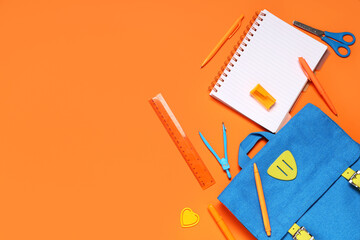 Composition with backpack and different school stationery on orange background, closeup
