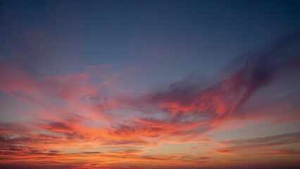 Magnificent sky at sunset painted in vibrant hues of orange, pink, and purple, with soft clouds drifting across the glowing horizon, creating a serene and breathtaking view of nature’s evening beauty